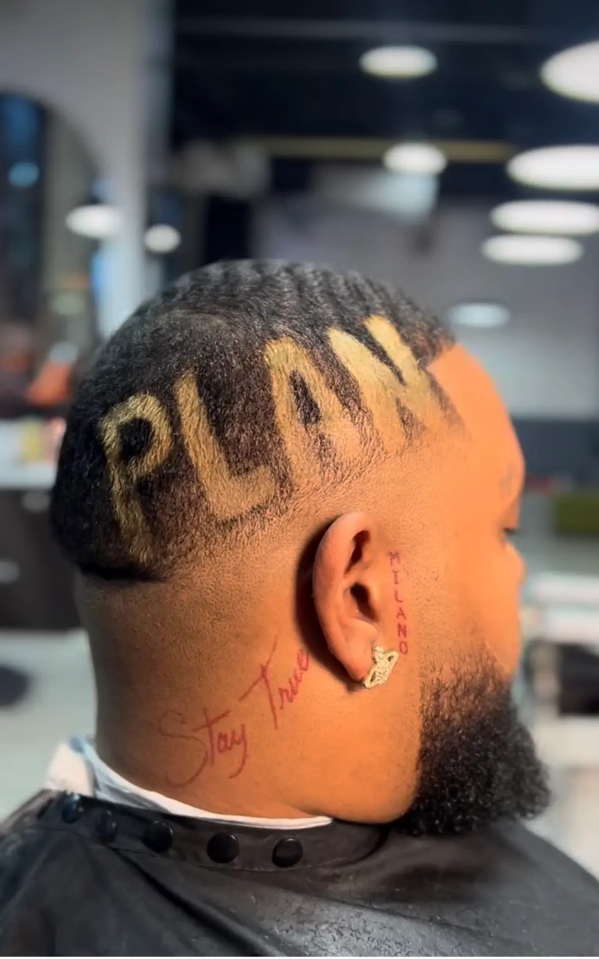 Custom 'Play' bleached hair lettering by Miami Mobile Barber